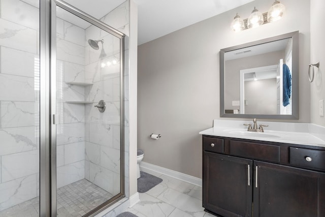 bathroom with marble finish floor, a marble finish shower, baseboards, and vanity