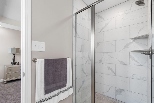 bathroom featuring a marble finish shower