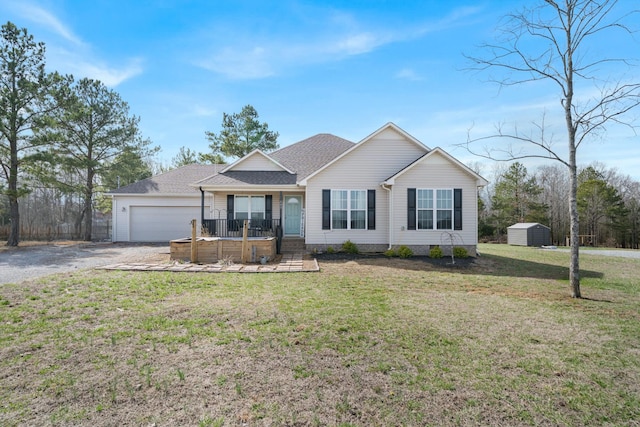 ranch-style house with a garage, covered porch, a front lawn, and a storage unit