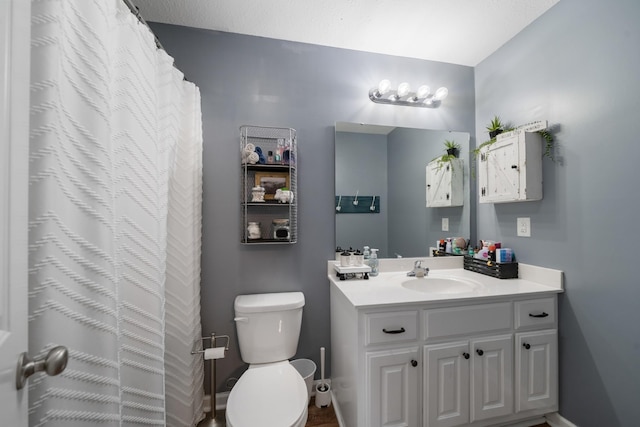 full bathroom with toilet and vanity