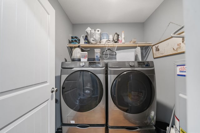 laundry area featuring laundry area, electric water heater, and washer and dryer