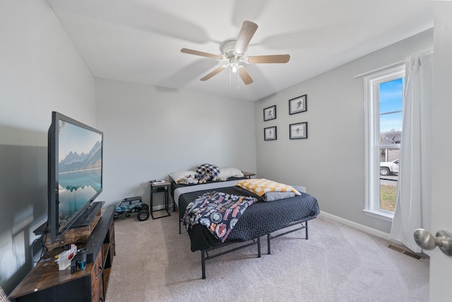 bedroom with light carpet, baseboards, visible vents, and a ceiling fan