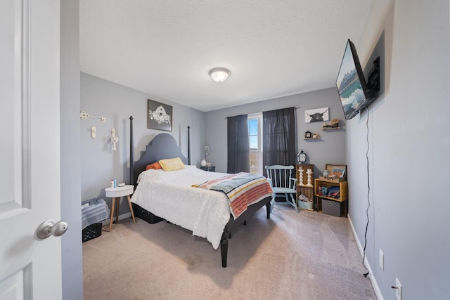 bedroom featuring carpet flooring, a textured ceiling, and baseboards
