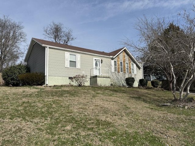 view of front of home with a front yard and crawl space