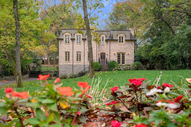 french country style house with a front lawn