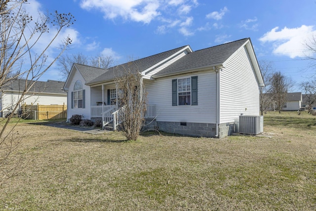 view of front of property with a front yard, crawl space, central AC, and covered porch