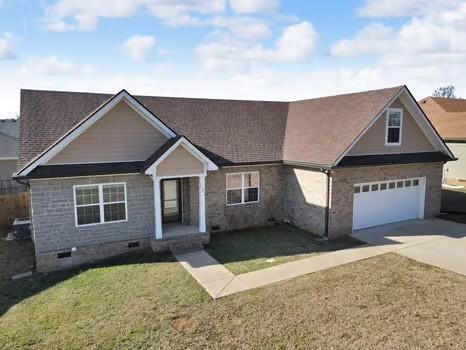 view of front of property featuring a front yard, crawl space, an attached garage, and concrete driveway