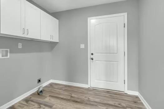 laundry area featuring hookup for a washing machine, cabinet space, hookup for an electric dryer, wood finished floors, and baseboards