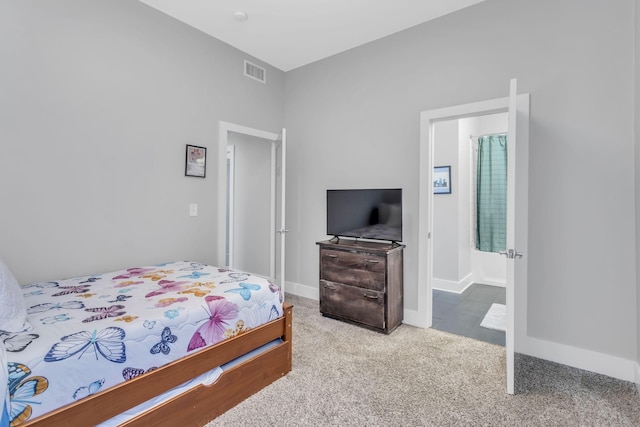 carpeted bedroom featuring baseboards and visible vents