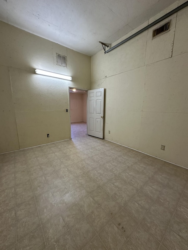 unfurnished room with visible vents and tile patterned floors