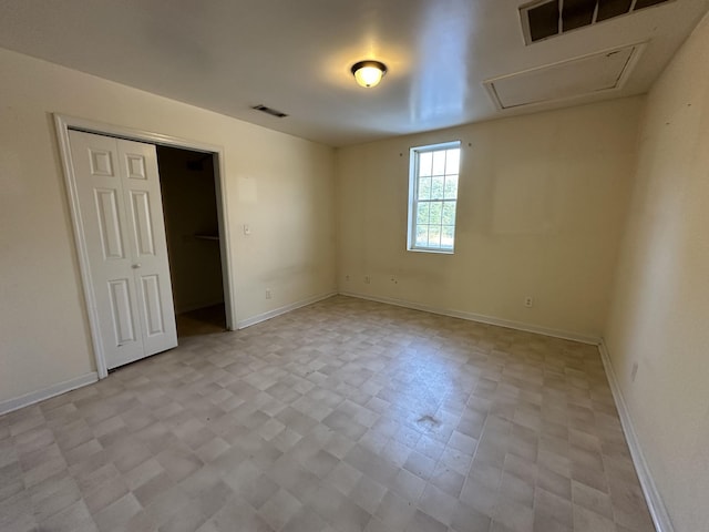 unfurnished bedroom featuring baseboards, visible vents, and a closet