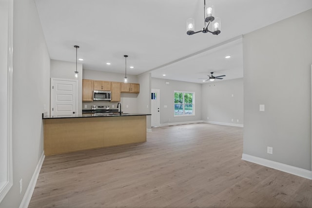 348 Welchwood Dr, Clarksville, TN 37040 - kitchen with stainless steel microwave, dark countertops, recessed lighting, and baseboards