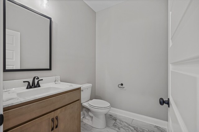 348 Welchwood Dr, Clarksville, TN 37040 - bathroom with vanity, toilet, marble finish floor, and baseboards