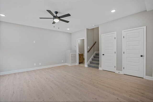 348 Welchwood Dr, Clarksville, TN 37040 - unfurnished living room with light wood finished floors, recessed lighting, a ceiling fan, stairs, and baseboards