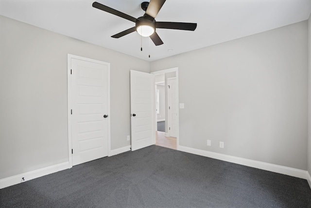 348 Welchwood Dr, Clarksville, TN 37040 - unfurnished bedroom featuring a ceiling fan, dark colored carpet, and baseboards