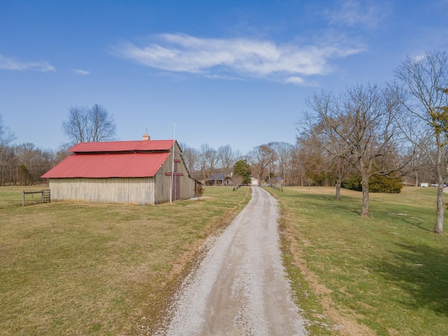 view of road with an outbuilding and driveway