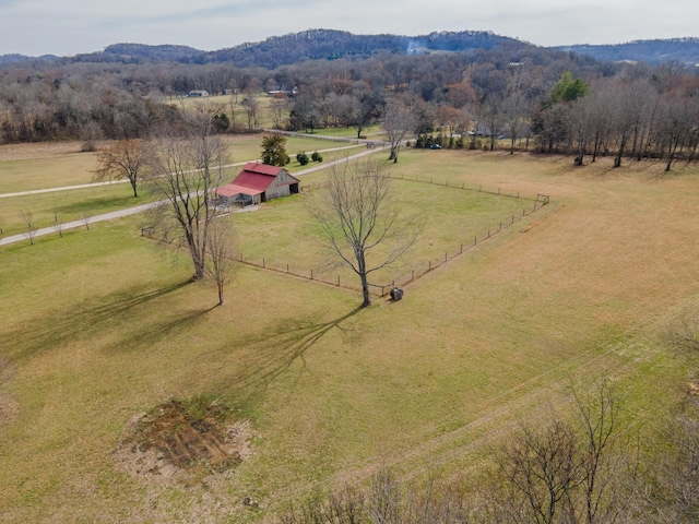 birds eye view of property with a mountain view, a wooded view, and a rural view