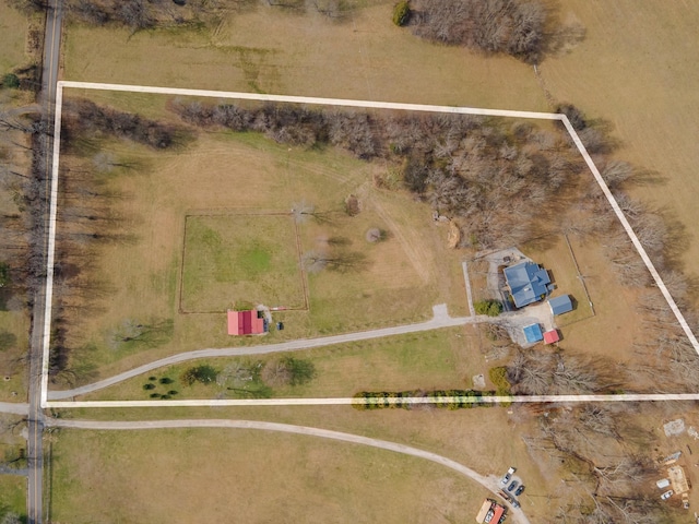 birds eye view of property with a rural view