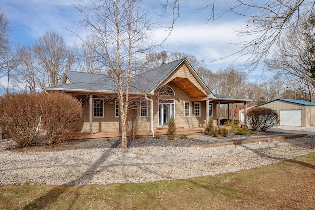 view of front of house featuring a porch, an outbuilding, and a garage