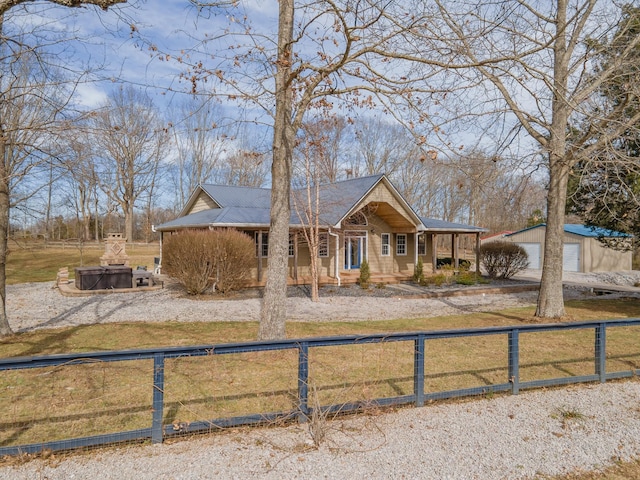 view of front facade featuring a fenced front yard, a front yard, and an outdoor structure