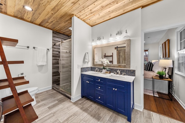 full bath featuring toilet, a sink, a shower stall, wood finished floors, and wooden ceiling