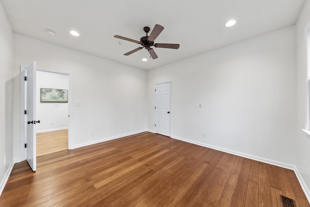 unfurnished room featuring recessed lighting, visible vents, baseboards, and hardwood / wood-style flooring