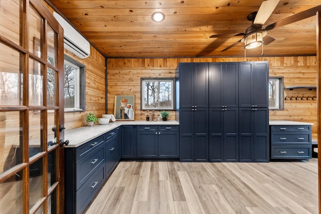 kitchen with light countertops, blue cabinetry, a wall mounted AC, and wooden ceiling