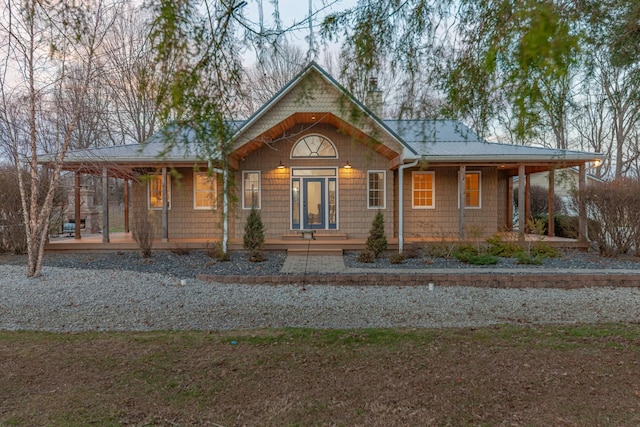 view of front facade featuring a porch and metal roof