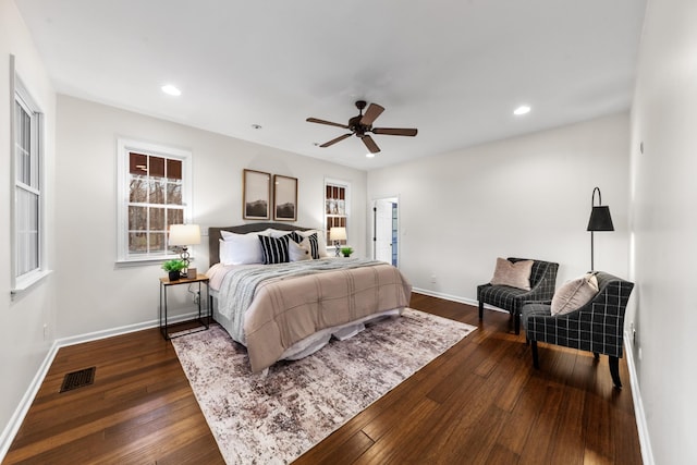 bedroom with recessed lighting, dark wood finished floors, visible vents, and baseboards