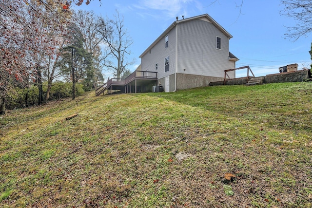 exterior space featuring central AC unit, stairway, a deck, and a lawn