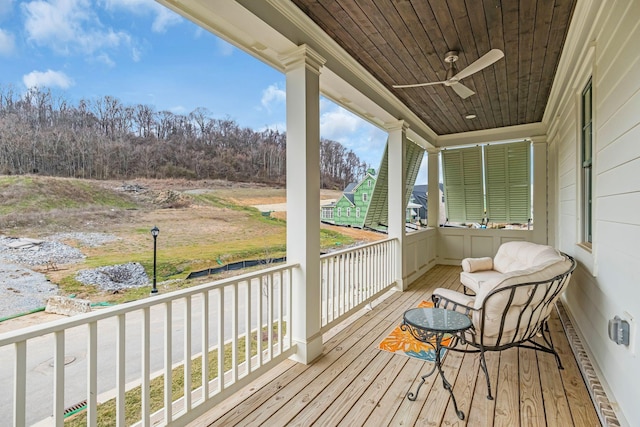 wooden terrace with covered porch and ceiling fan