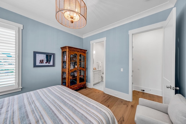 bedroom with crown molding, an inviting chandelier, light wood-style floors, connected bathroom, and baseboards