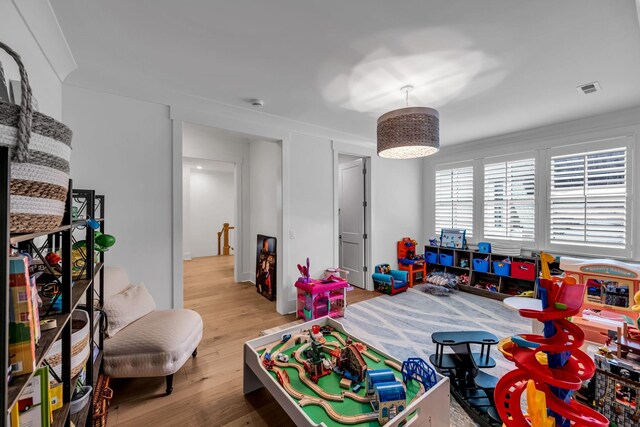 game room with visible vents and light wood finished floors