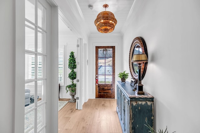 entryway featuring light wood-style floors and ornamental molding