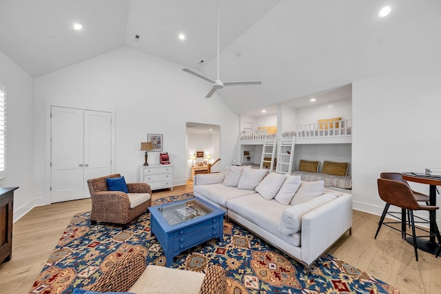 living area with light wood-style floors, high vaulted ceiling, a ceiling fan, and recessed lighting