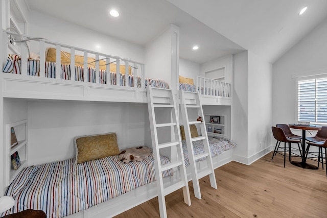 bedroom with light wood-type flooring, baseboards, vaulted ceiling, and recessed lighting