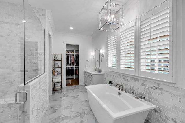 bathroom featuring a stall shower, ornamental molding, marble finish floor, a freestanding bath, and recessed lighting