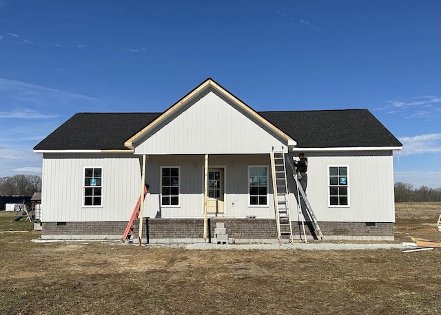 view of front of home featuring crawl space, a shingled roof, and a porch