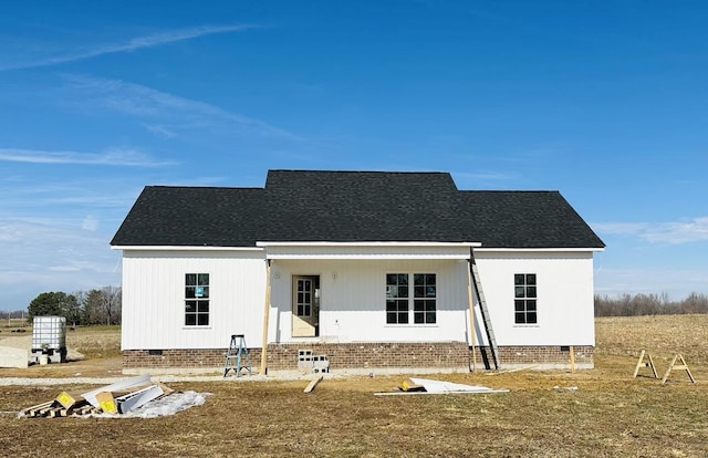 modern farmhouse featuring a shingled roof and crawl space