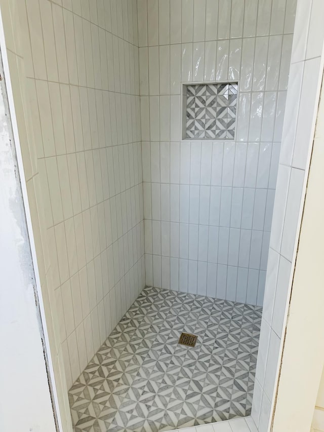 full bathroom with a tile shower