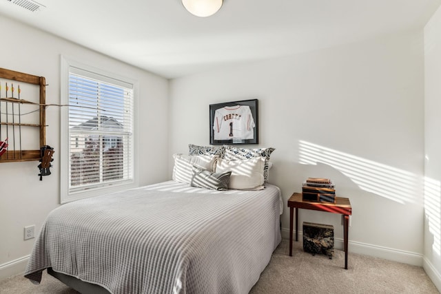 bedroom with light carpet, visible vents, and baseboards