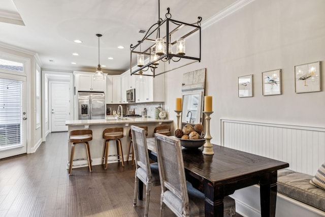 dining area with recessed lighting, dark wood-style flooring, visible vents, and crown molding