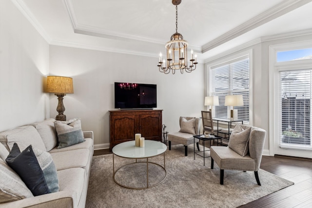 living room with crown molding, a raised ceiling, and wood finished floors