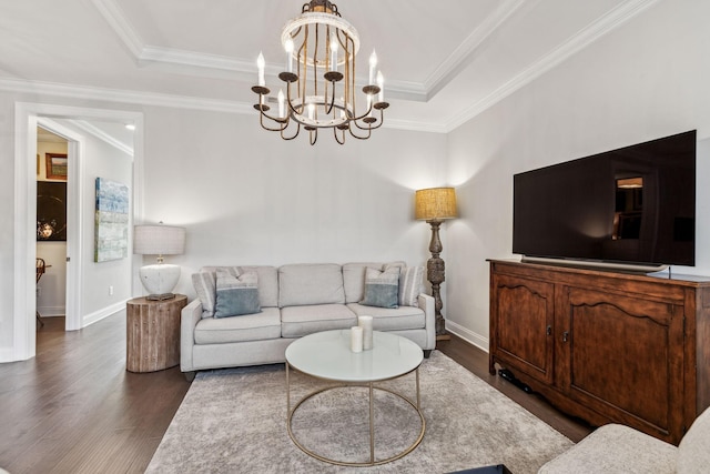 living area featuring ornamental molding, a tray ceiling, and dark wood finished floors