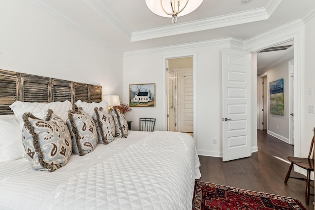 bedroom featuring baseboards, dark wood finished floors, and crown molding