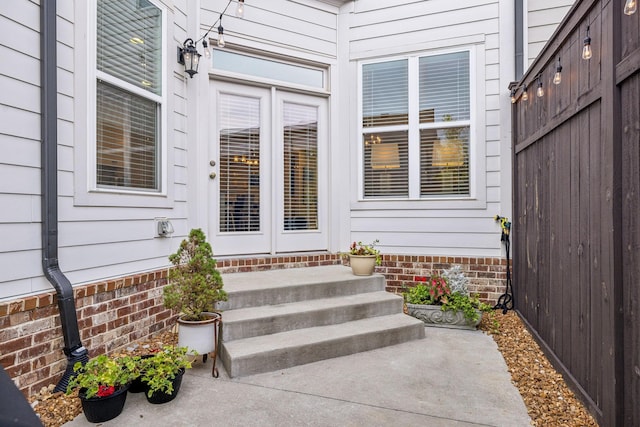 doorway to property with fence and a patio