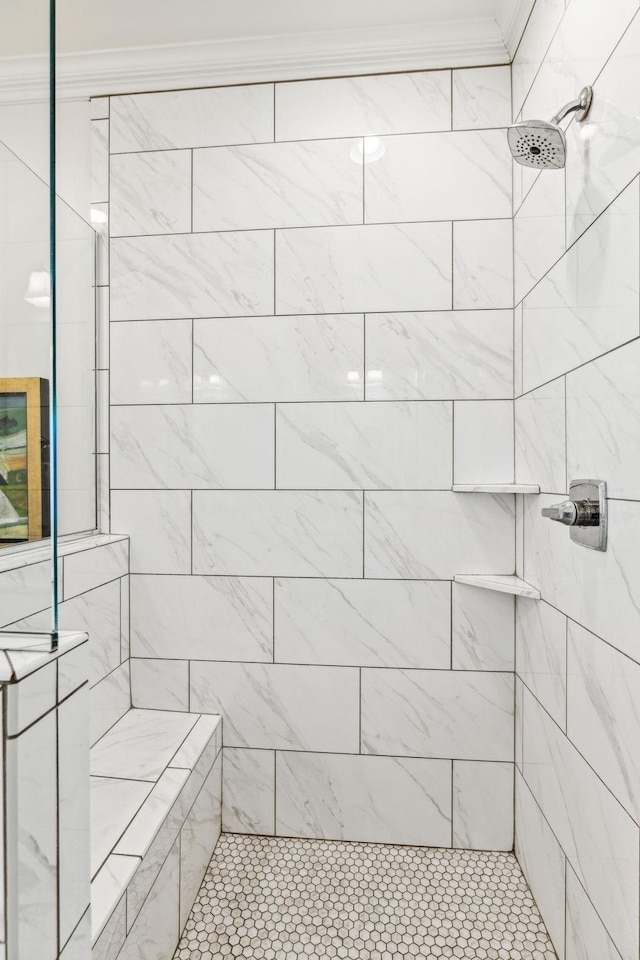 full bathroom with ornamental molding and tiled shower