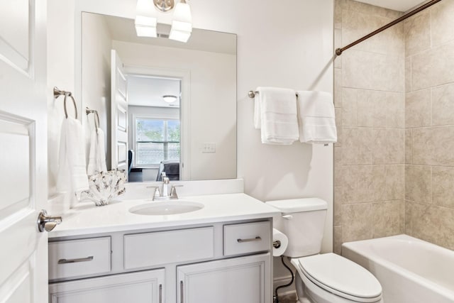 bathroom featuring vanity, bathtub / shower combination, ensuite bath, and toilet