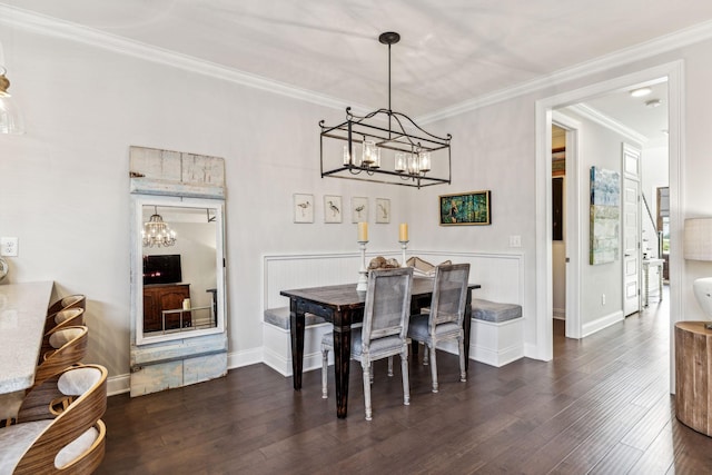 dining space featuring a chandelier, ornamental molding, dark wood-style flooring, and baseboards