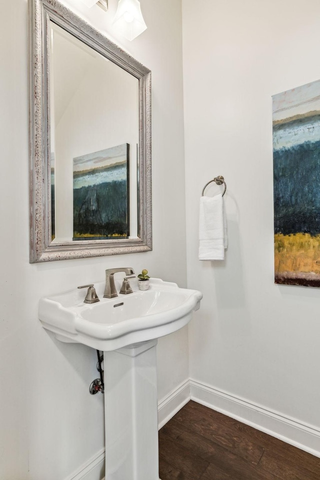 bathroom featuring wood finished floors and baseboards